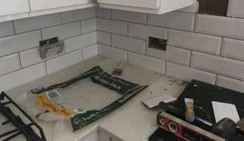 A kitchen garbage disposal unit being fixed